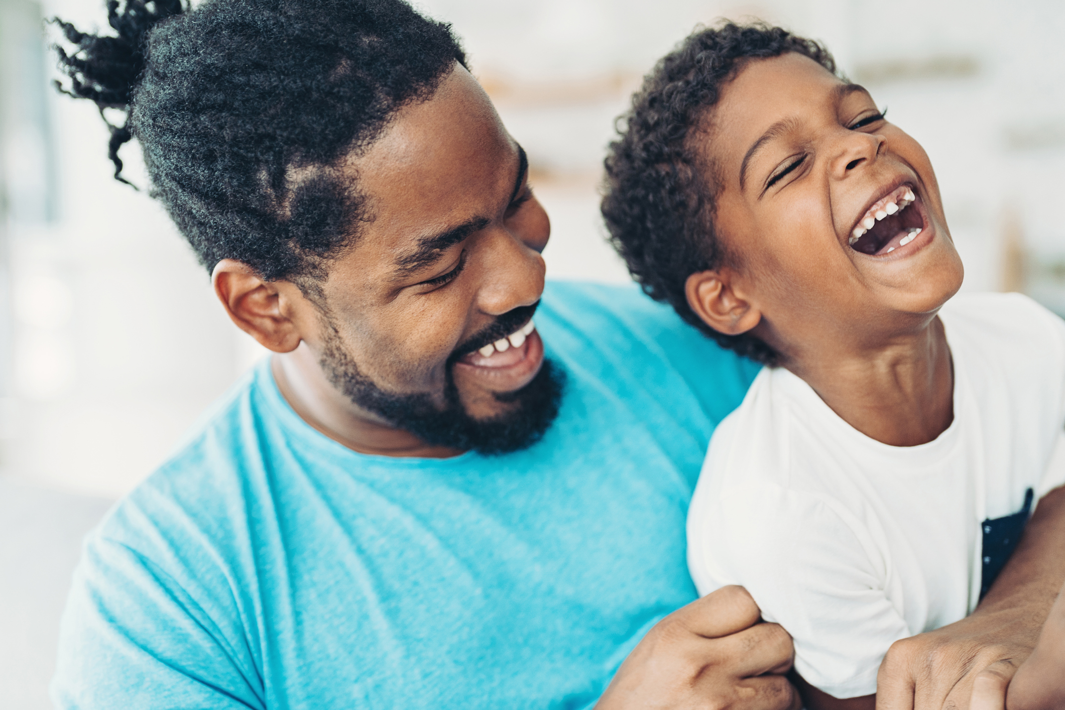 Father and son smiling with healthy teeth