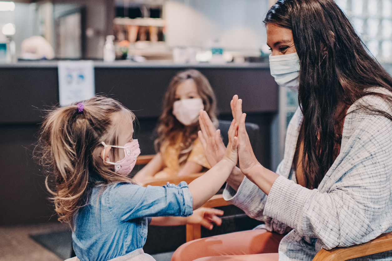 Family Dentist, mother with children in waiting room