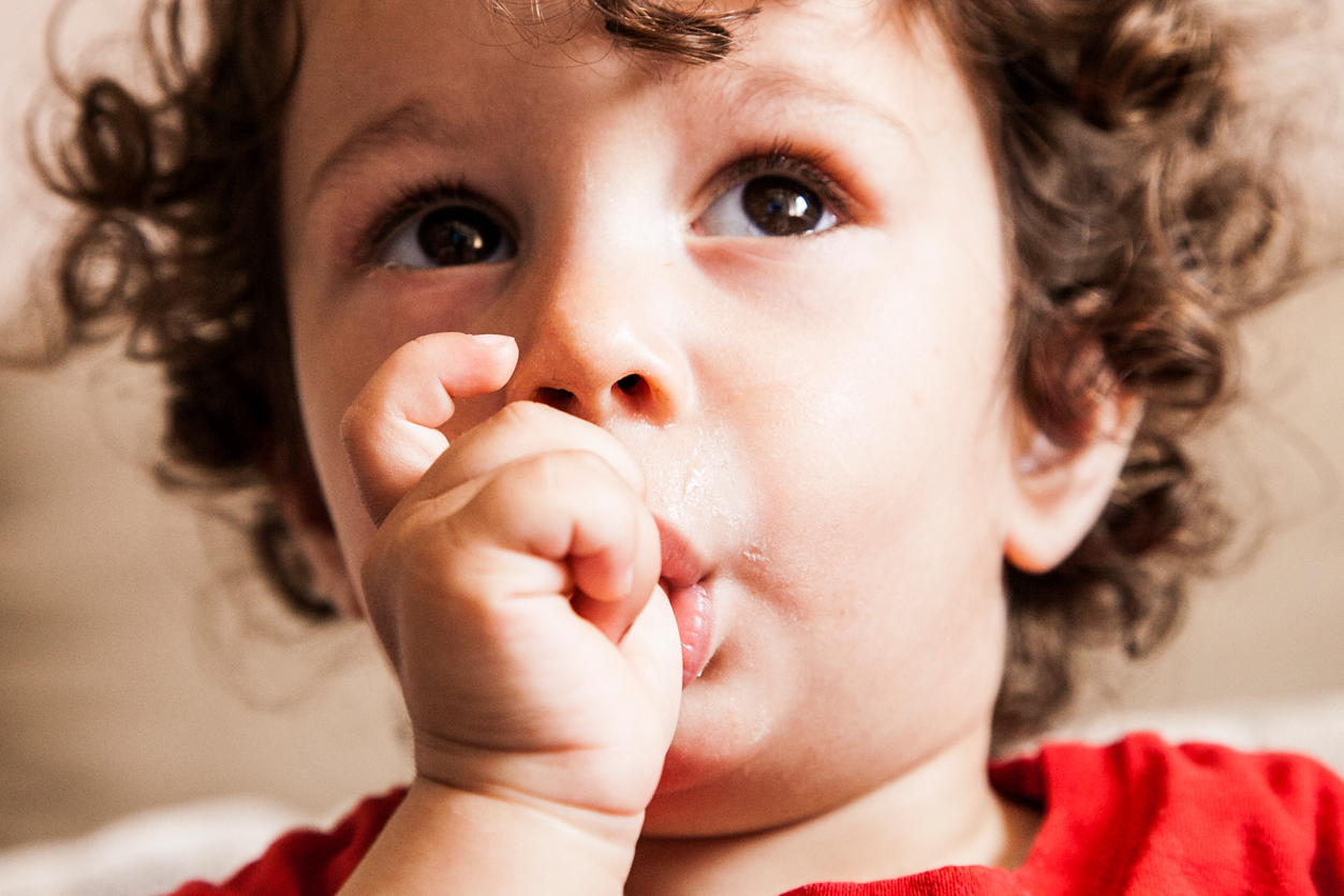 Thumbsucking, small child with thumb in mouth