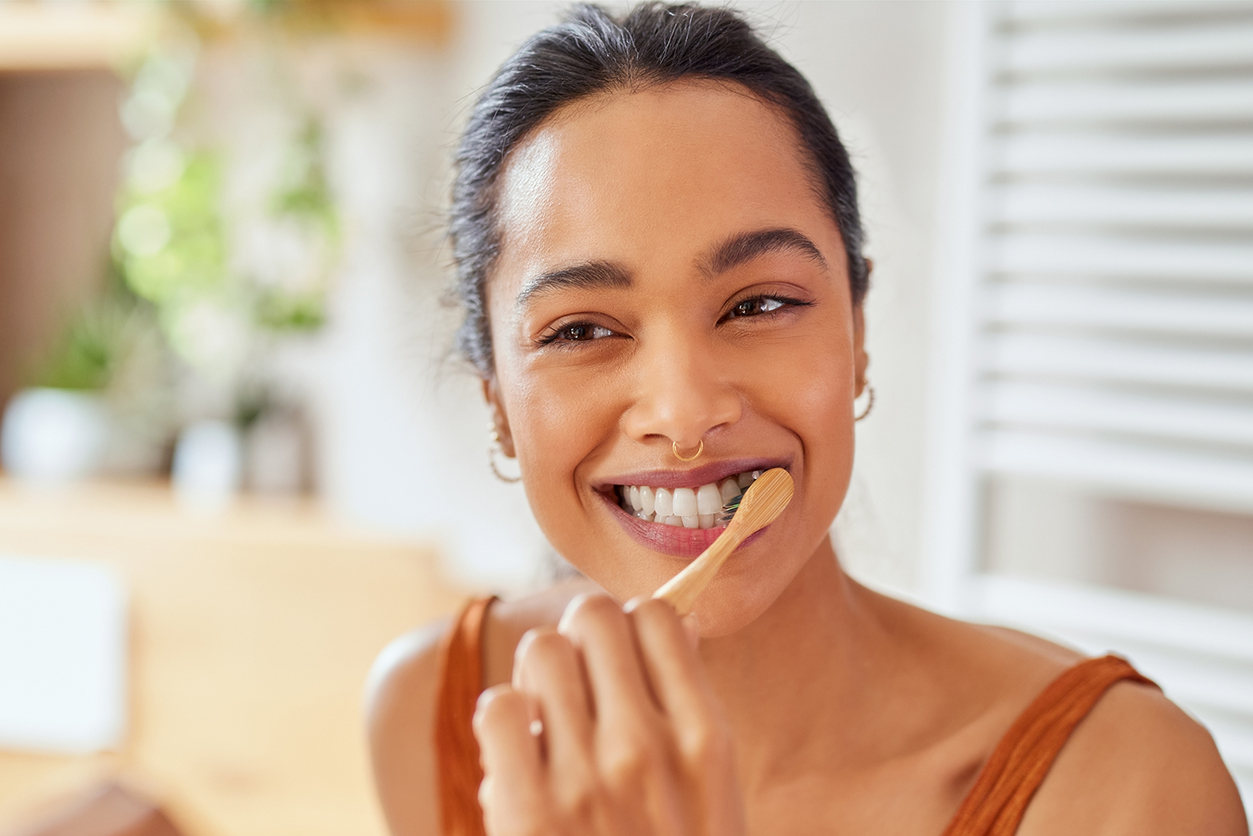 Multiethnic girl cleaning teeth in the morning time.