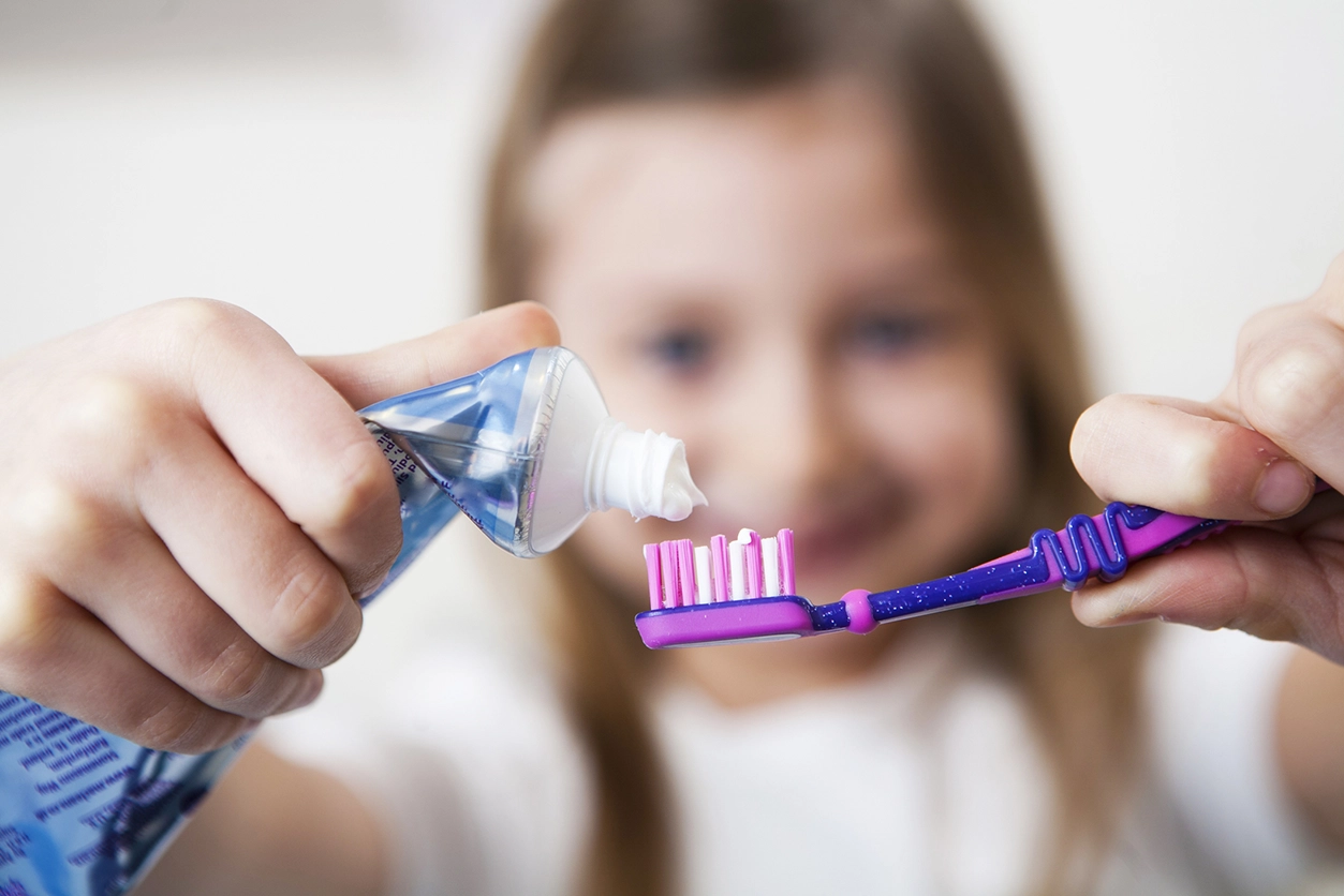 Best Toothbrush for Kids - child girl holding toothbrush and toothpaste