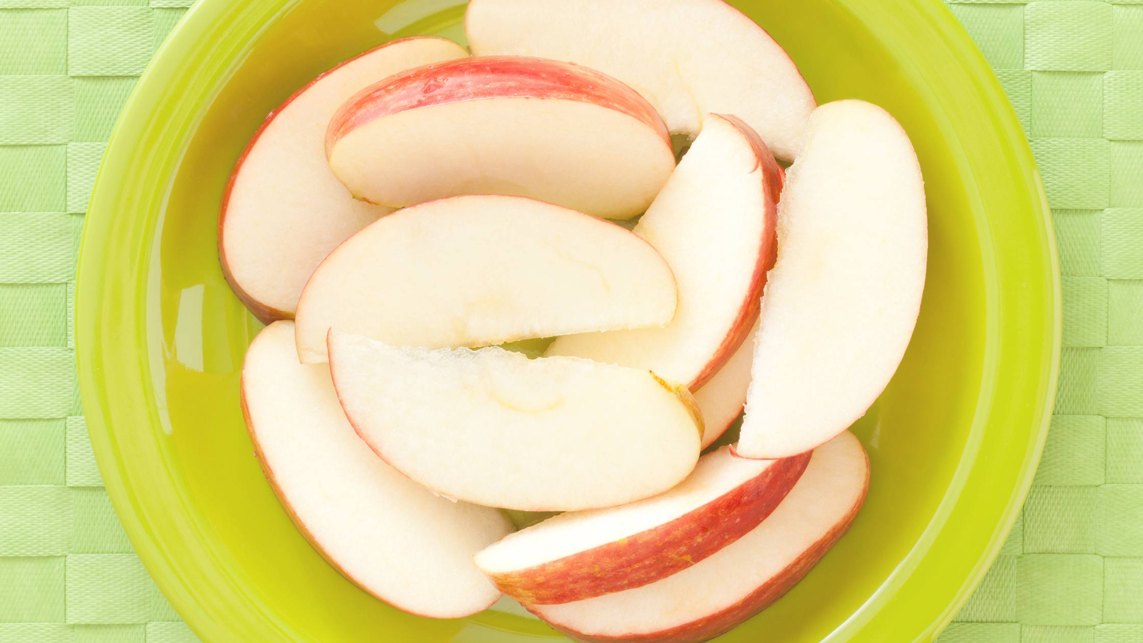 Plate of sliced apples for a healthy snack for your smile