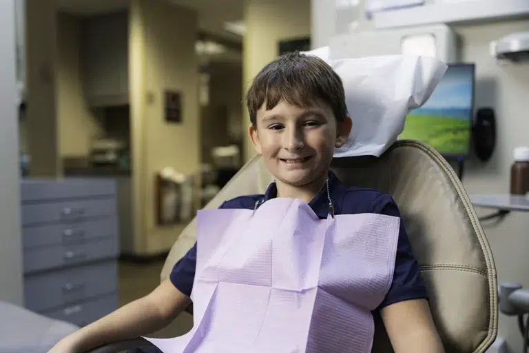 Smiling young boy in a dental chair