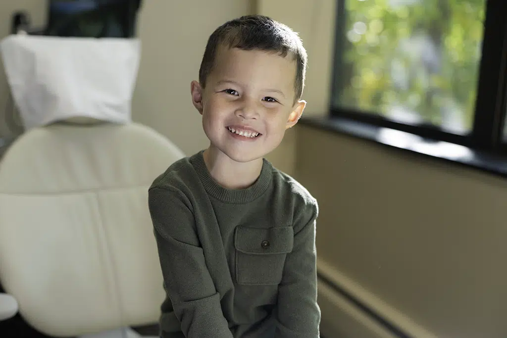 Young boy smiling in dental chair