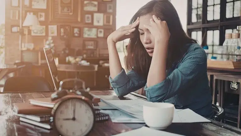 Stressed woman at work unable to get to her dentist appointment