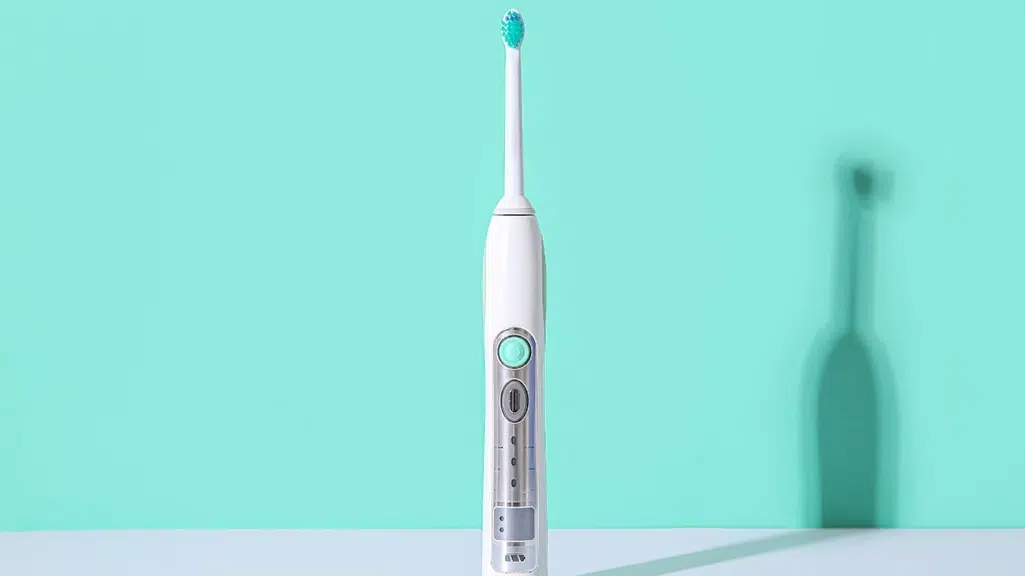 Green background with electric toothbrush