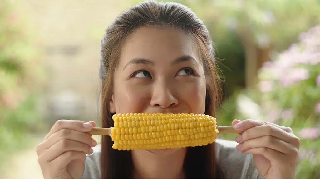woman eating corn on the cob